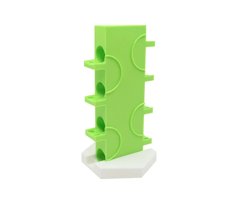 Demi-tour vertical vert sur son support blanc, vue de trois quarts